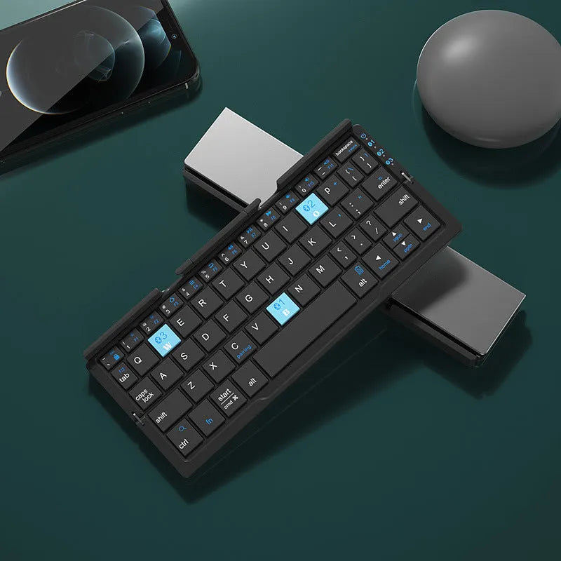 Silver white folding Bluetooth keyboard with integrated stand holding a smartphone