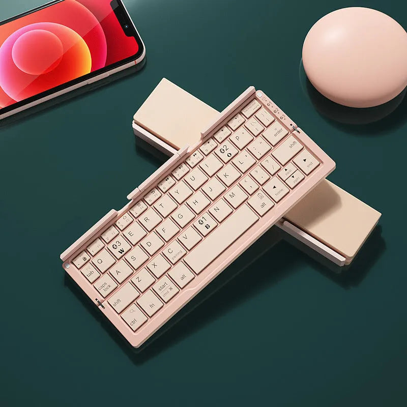 Silver white folding Bluetooth keyboard with integrated stand holding a smartphone