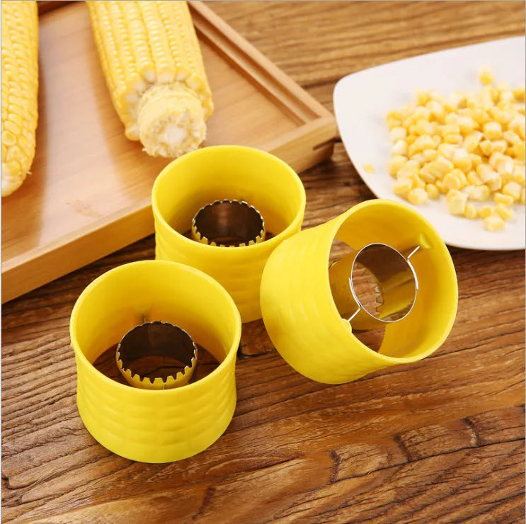 Yellow corn-shaped manual kitchen thresher tool for removing kernels from corn on the cob.