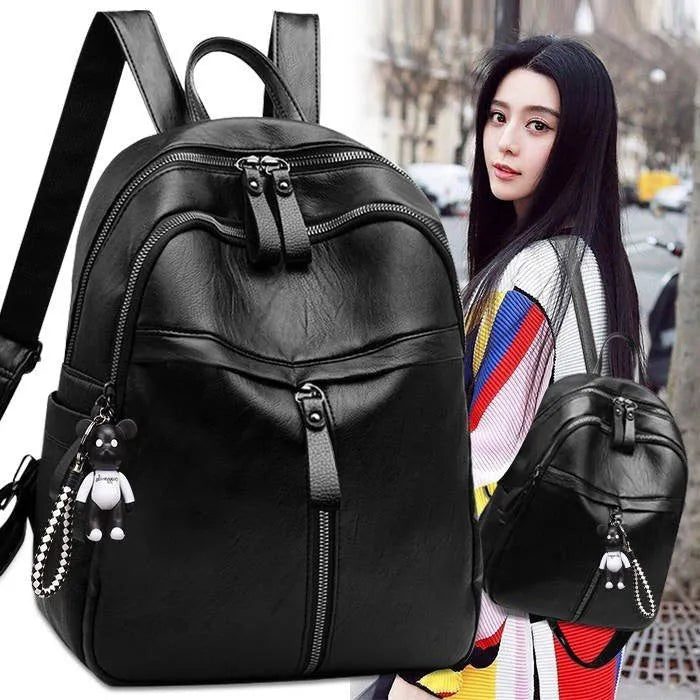 Black PU leather backpack with double straps showing internal ID bag compartment and zipper closure