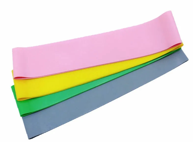 Latex resistance band in pink, measuring 500mm length, 50mm width, for yoga and fitness exercises