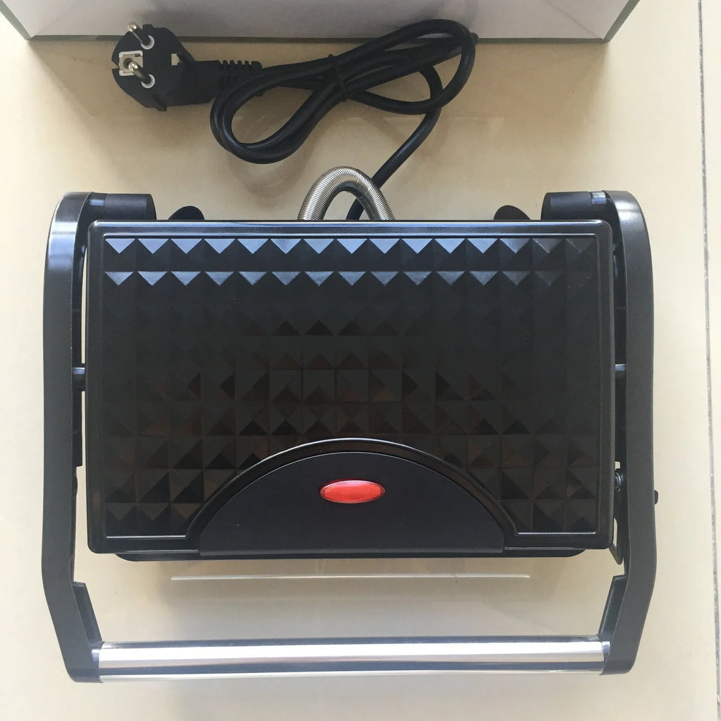 Nonstick electric steak maker grill with black casing, adjustable temperature knob, and wrap-around power cord on a kitchen worktop.
