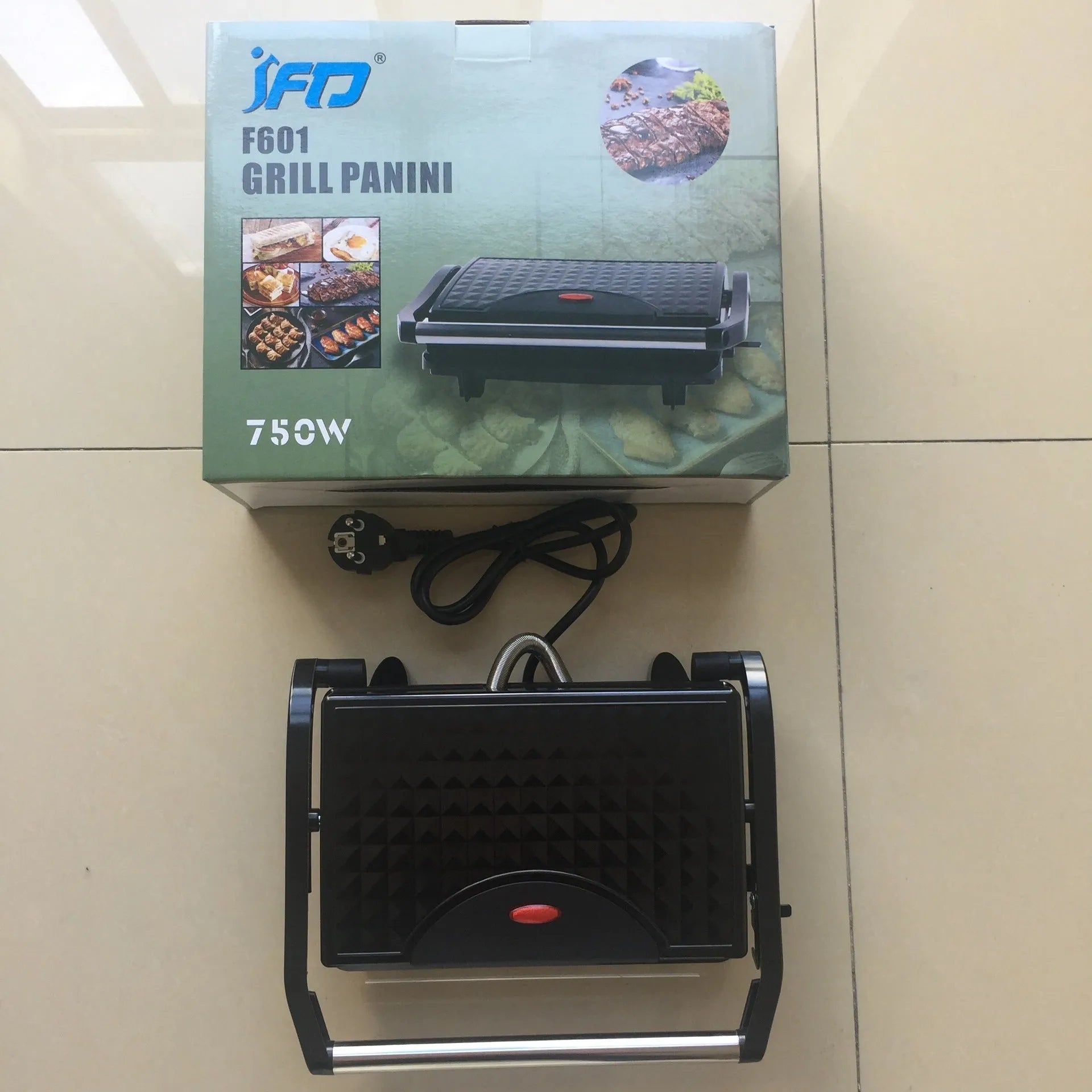 Nonstick electric steak maker grill with black casing, adjustable temperature knob, and wrap-around power cord on a kitchen worktop.