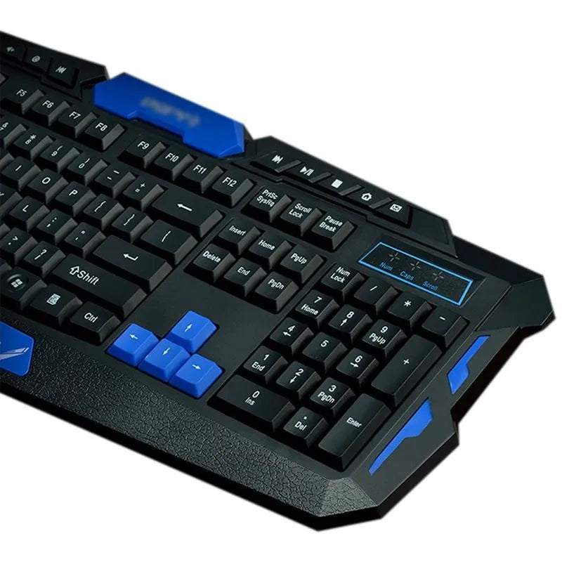 Black and blue wireless keyboard and mouse set on a desk, showing ergonomic design and multimedia keys.