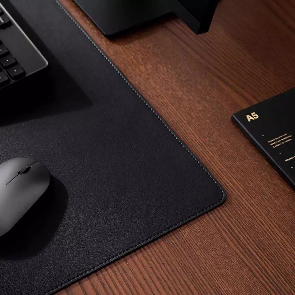 Extra large double-material waterproof mouse pad in black with storage bag on desk
