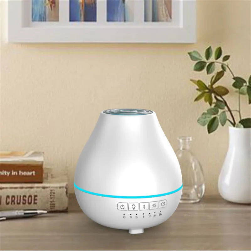 White round Bluetooth humidifier and essential oil aroma diffuser with night light on a table.