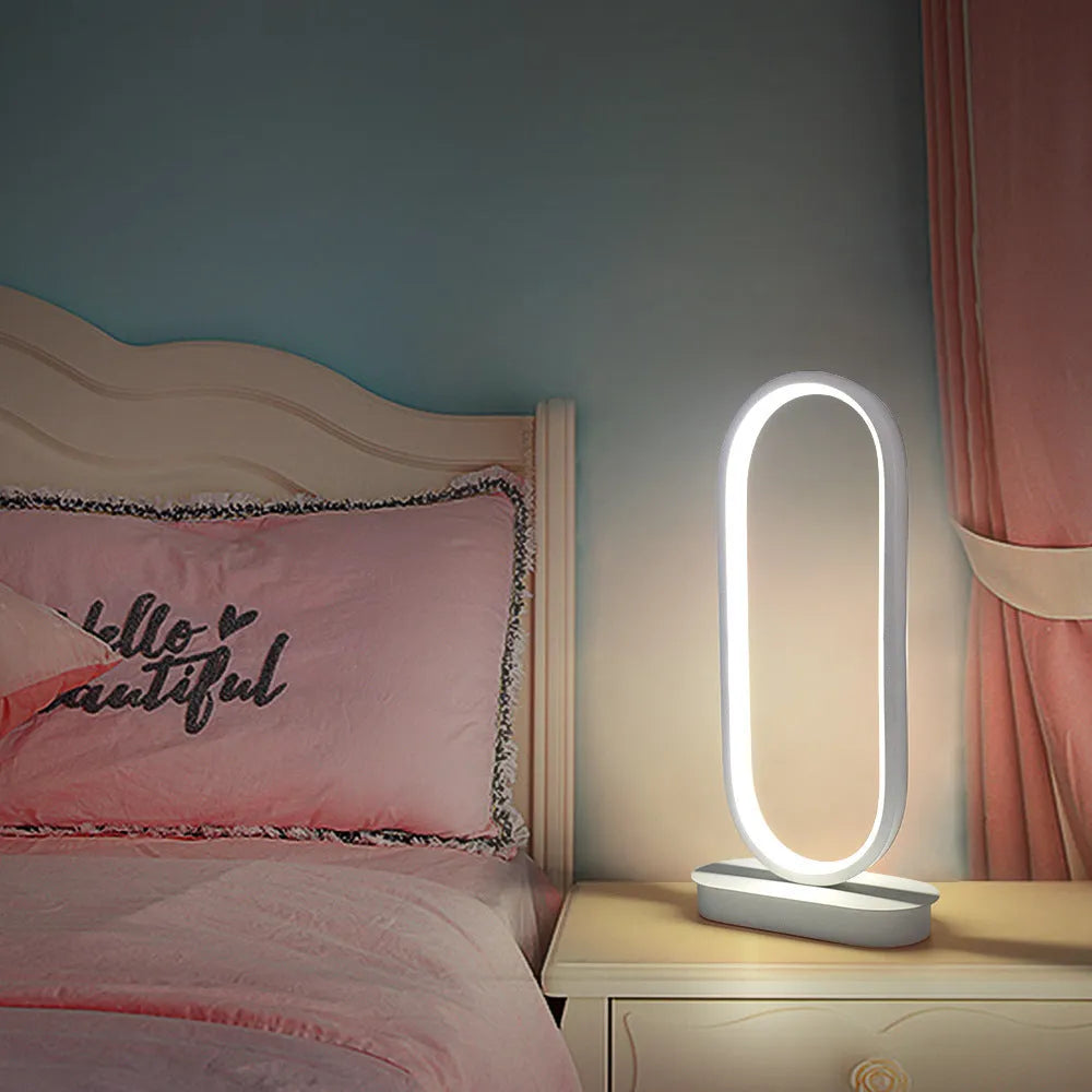 Oval LED table lamp with metal lampshade, push button switch, 18W, 45cm tall, black finish, on a wooden table