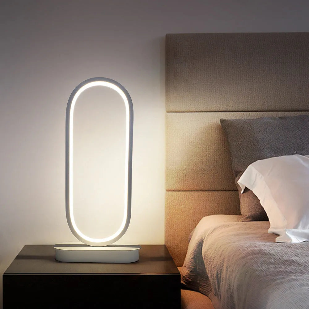 Oval LED table lamp with metal lampshade, push button switch, 18W, 45cm tall, black finish, on a wooden table