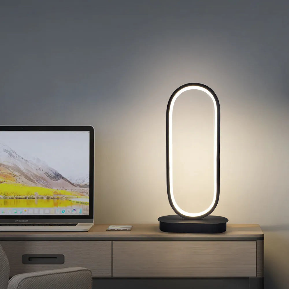 Oval LED table lamp with metal lampshade, push button switch, 18W, 45cm tall, black finish, on a wooden table