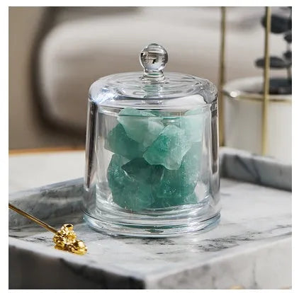 Crystal diffuser stone in pink with sesame oil bottle on a wooden surface for fire-free aromatherapy