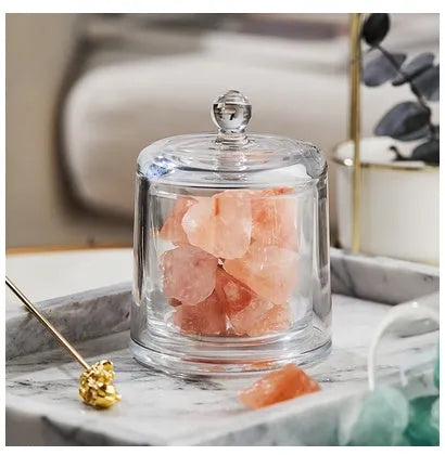 Crystal diffuser stone in pink with sesame oil bottle on a wooden surface for fire-free aromatherapy