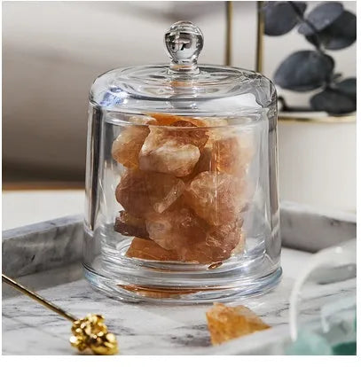 Crystal diffuser stone in pink with sesame oil bottle on a wooden surface for fire-free aromatherapy