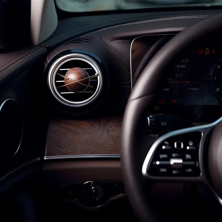 Wooden asteroid car diffuser clipping onto air vent with creative fragrance design