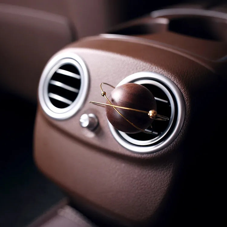 Wooden asteroid car diffuser clipping onto air vent with creative fragrance design