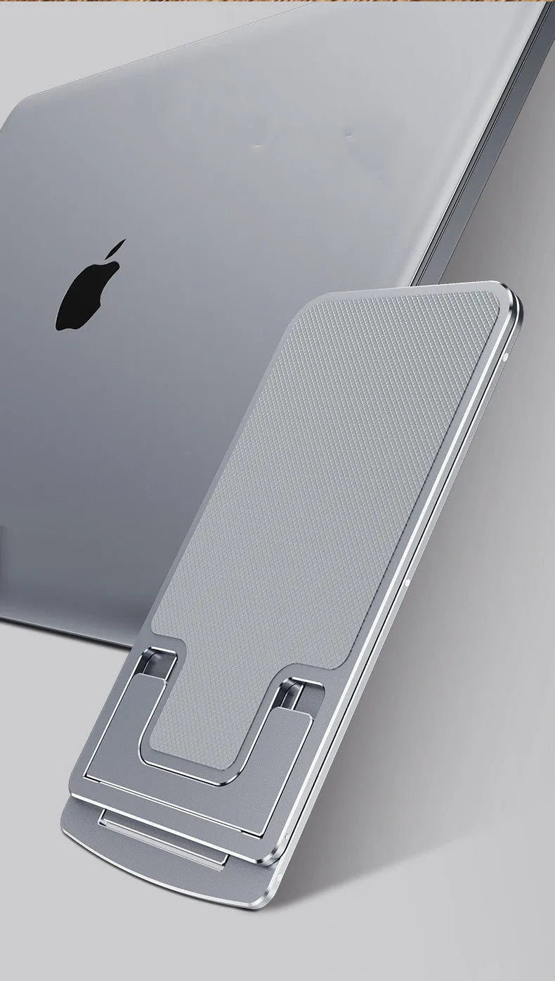 Foldable aluminum alloy phone holder in space gray on a desk holding an iPhone