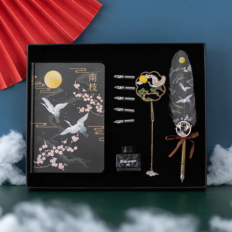 Chinese style feather pen set with metal sheath, 36 coloured refills, and Jianhegui notebook on a table.