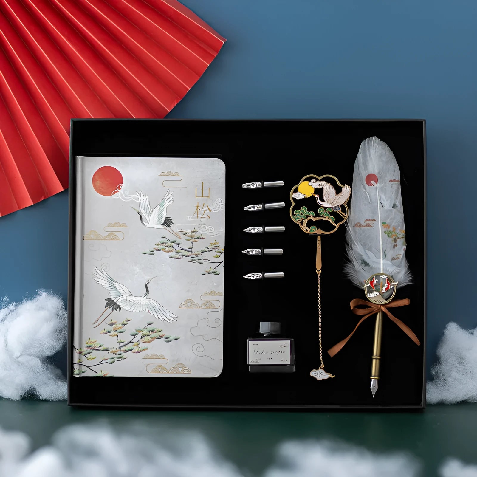 Chinese style feather pen set with metal sheath, 36 coloured refills, and Jianhegui notebook on a table.