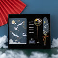 Chinese style feather pen set with metal sheath, 36 coloured refills, and Jianhegui notebook on a table.