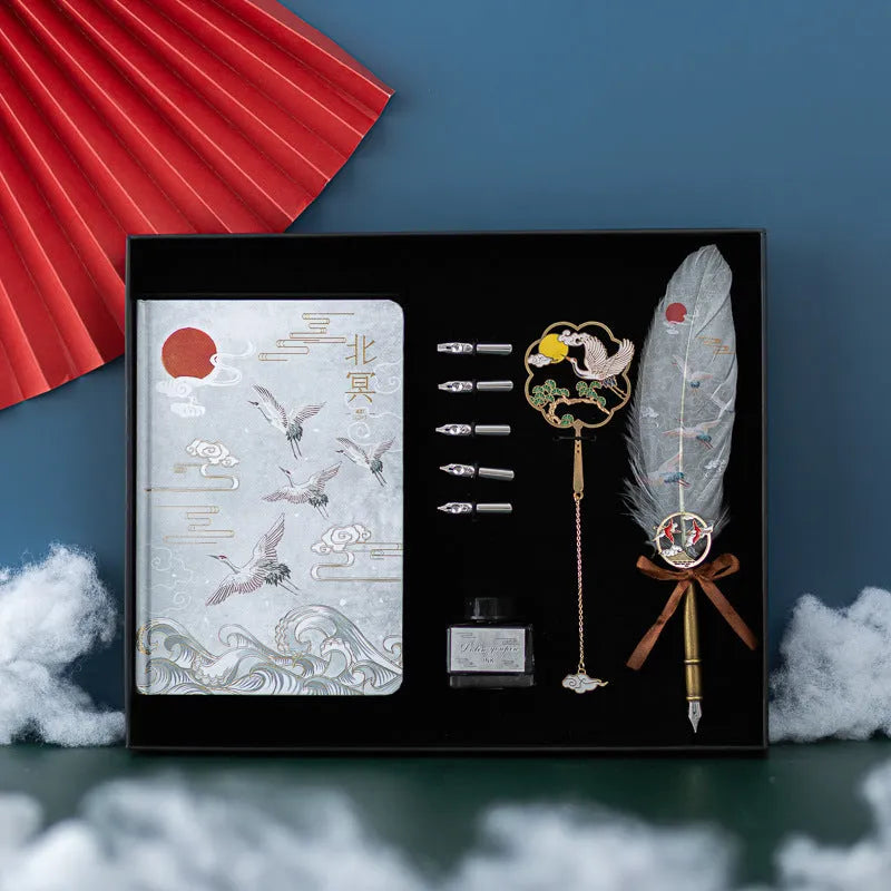 Chinese style feather pen set with metal sheath, 36 coloured refills, and Jianhegui notebook on a table.