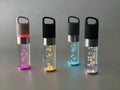 Pink cartoon-style portable Bluetooth speaker with colourful crystal lights on a desk.