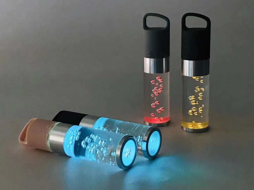 Pink cartoon-style portable Bluetooth speaker with colourful crystal lights on a desk.