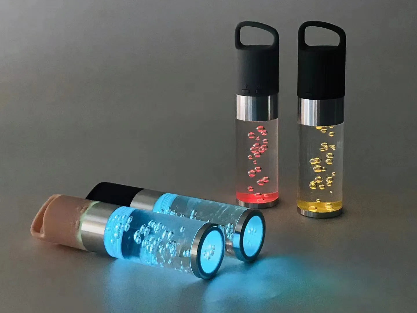 Pink cartoon-style portable Bluetooth speaker with colourful crystal lights on a desk.