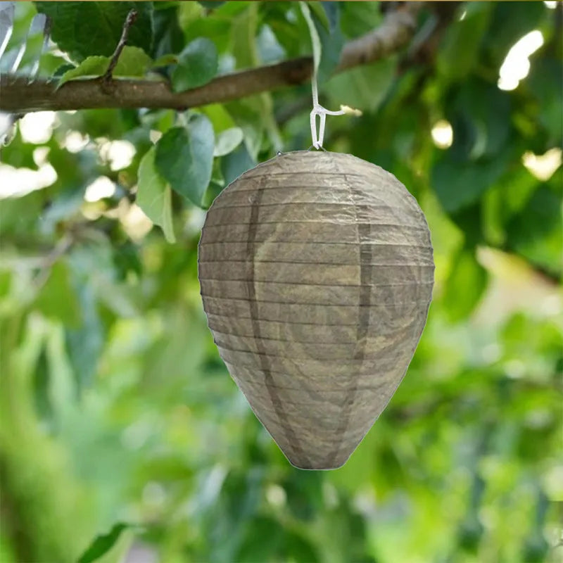A rectangular photo colour beehive lantern with a honeycomb paper structure and wire frame.