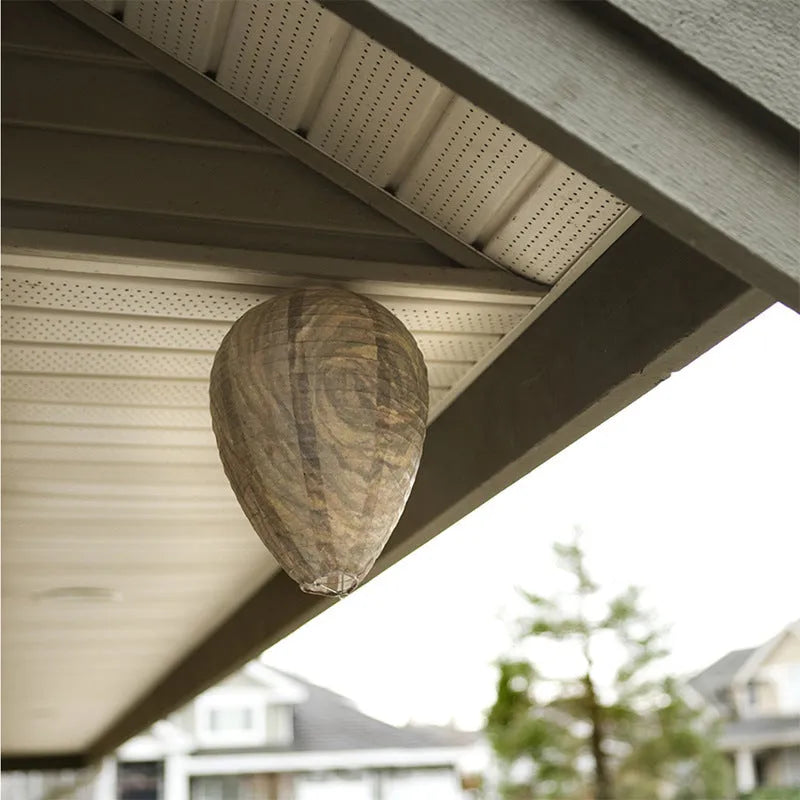 A rectangular photo colour beehive lantern with a honeycomb paper structure and wire frame.