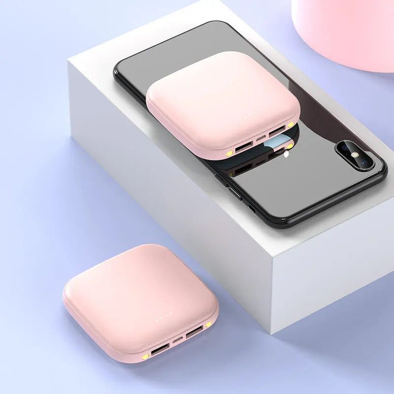 Compact black mini power bank with 20000 mAh capacity and LED flashlight on white background.