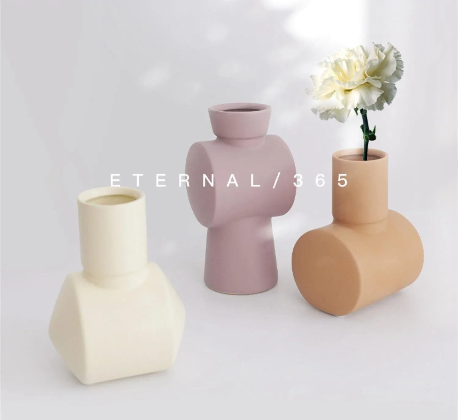 Minimalist ceramic vase with hammer glaze in beige, brown, or purple on a shelf.