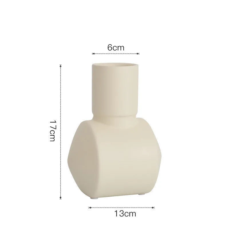 Minimalist ceramic vase with hammer glaze in beige, brown, or purple on a shelf.