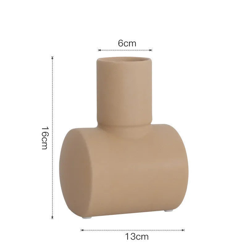 Minimalist ceramic vase with hammer glaze in beige, brown, or purple on a shelf.
