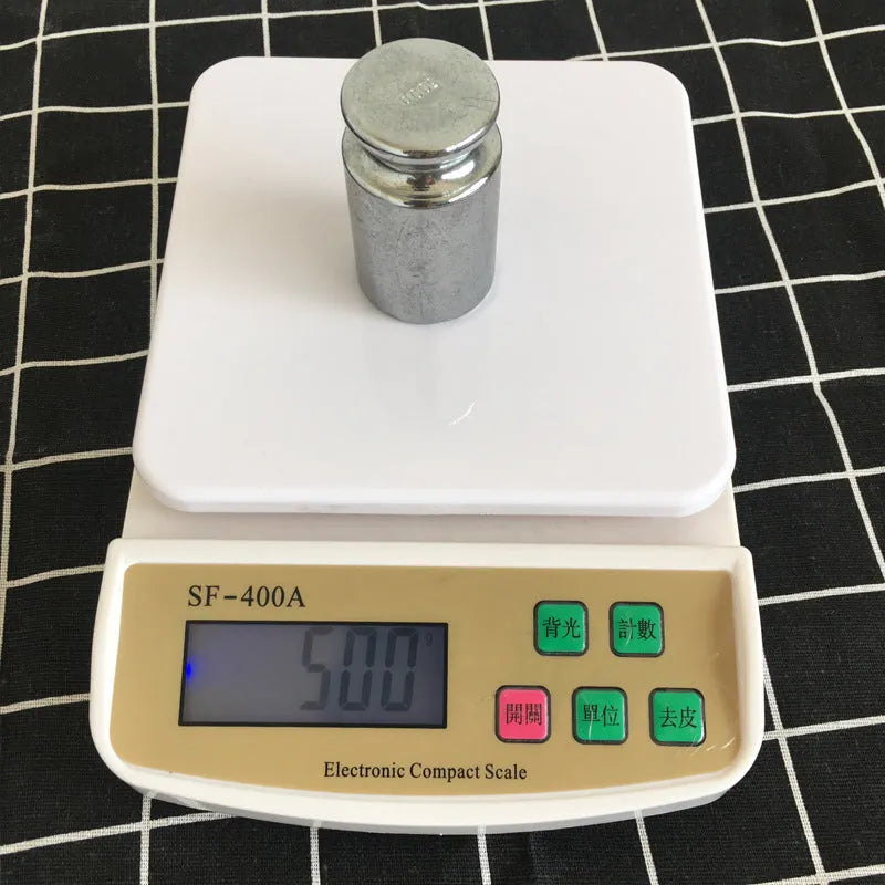 Electronic kitchen scale with digital display showing weight measurement, powered by AA batteries