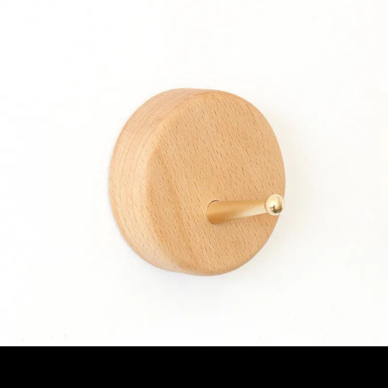 Solid beech wood adhesive wall hook with brass fitting in five shapes: capsule, diamond, oval, round, square.