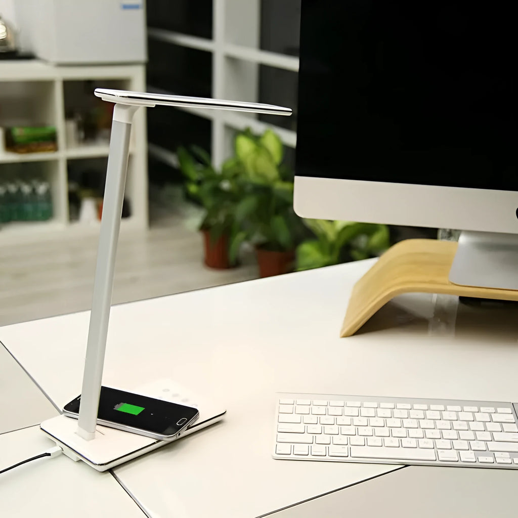 Black wireless charging LED desk lamp with touch control and USB cable on a wooden desk.