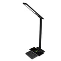 Black wireless charging LED desk lamp with touch control and USB cable on a wooden desk.