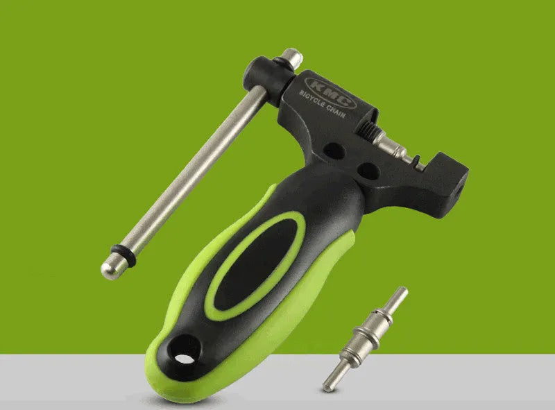 Green steel bicycle chain cutter tool with double shaft chaining device on a workbench