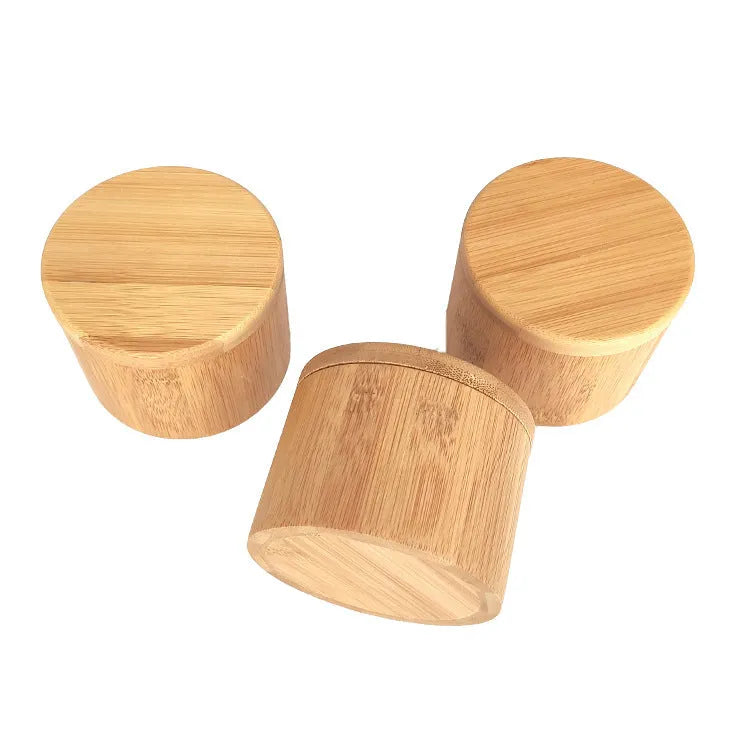Bamboo spice storage set with a square box, pear-shaped jar, round container, and a small bamboo spoon.