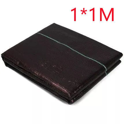 Black plastic woven weed-proof cloth laid flat on soil.