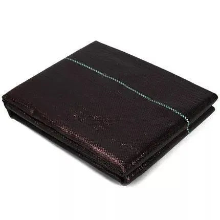 Black plastic woven weed-proof cloth laid flat on soil.