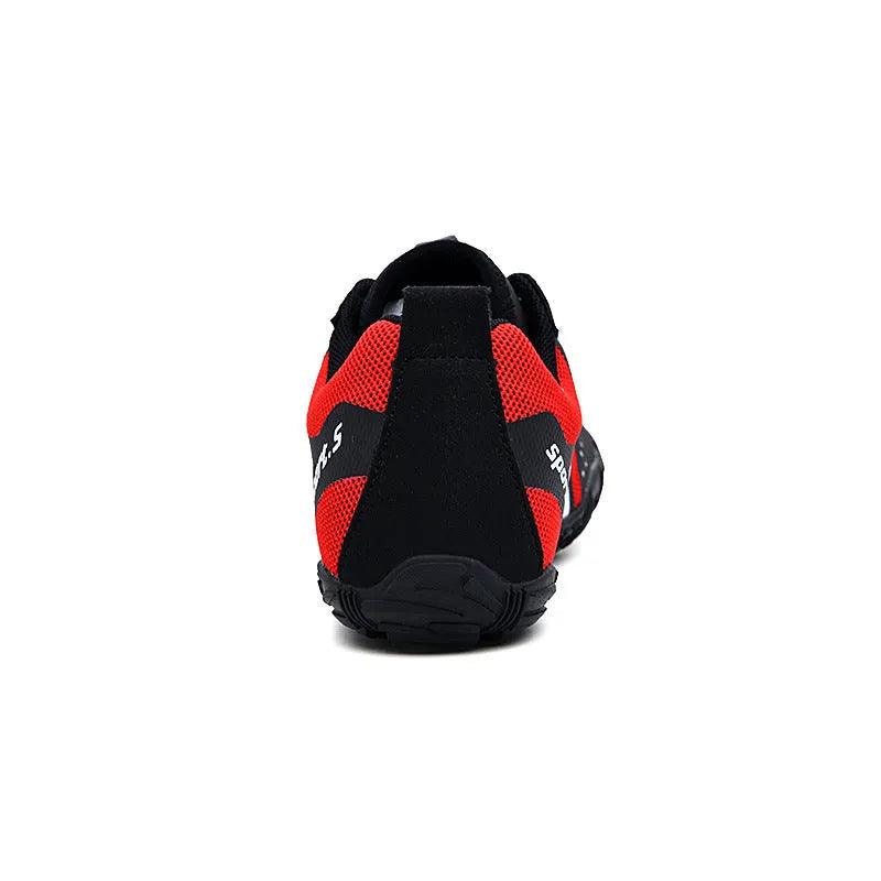 Red outdoor wading shoes with mesh upper and rubber sole on a sandy beach.