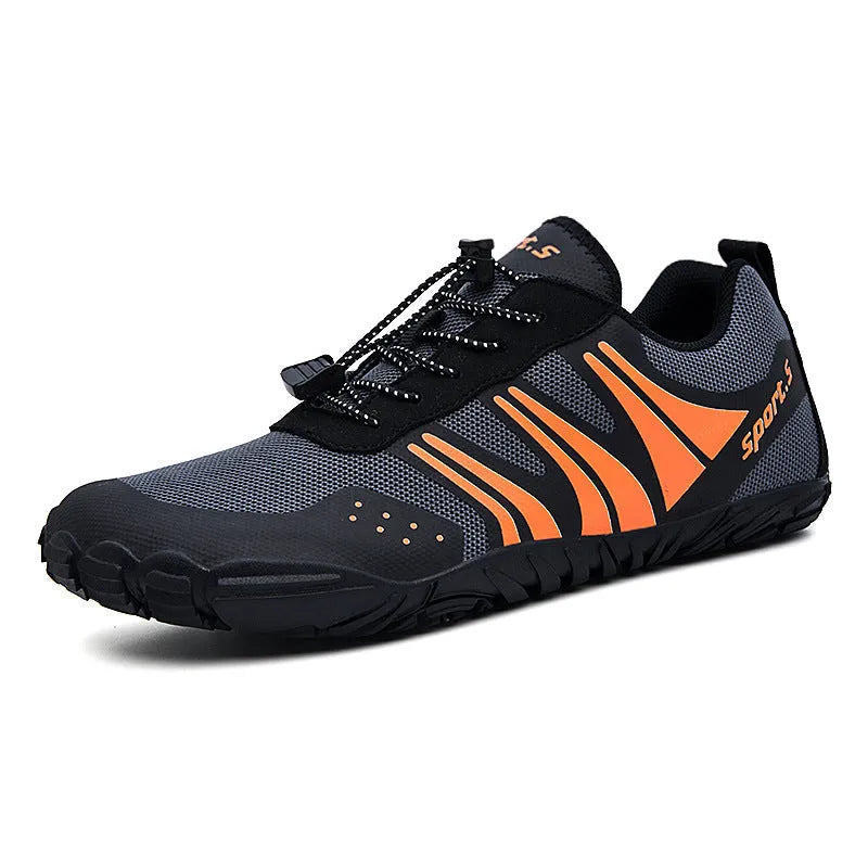Red outdoor wading shoes with mesh upper and rubber sole on a sandy beach.