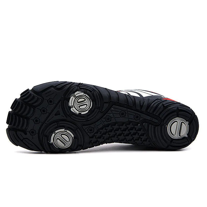 Red outdoor wading shoes with mesh upper and rubber sole on a sandy beach.