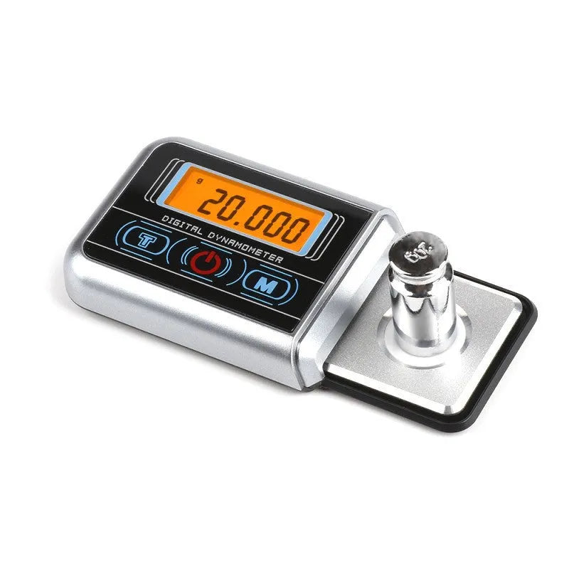 A compact digital electronic scale with a 100g capacity and 0.005g precision, shown weighing small items.