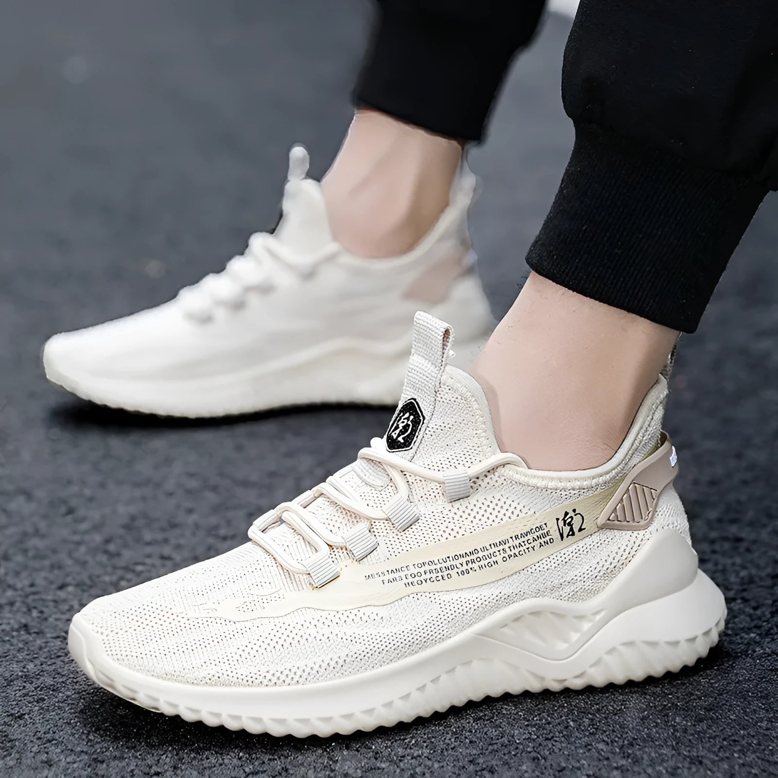 Men's low-top white mesh sports shoes with rubber sole and front-tie laces on a plain background.