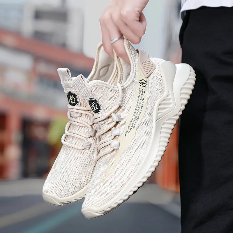 Men's low-top white mesh sports shoes with rubber sole and front-tie laces on a plain background.
