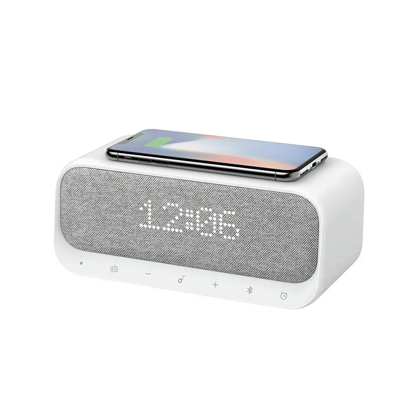 Anker Soundcore white Bluetooth speaker with wireless charging pad and digital alarm clock display