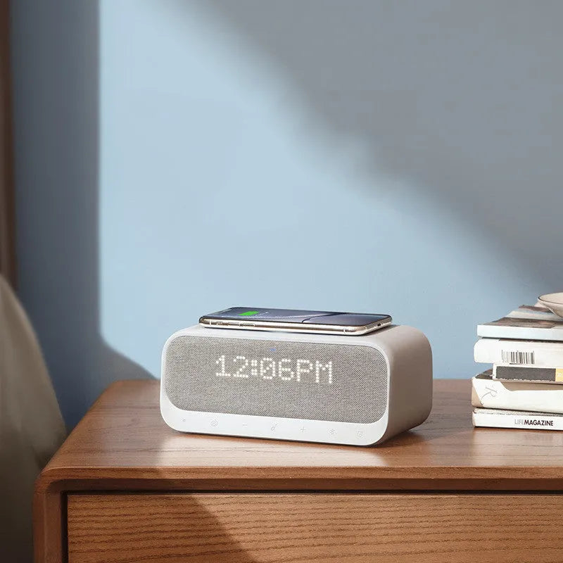 Anker Soundcore white Bluetooth speaker with wireless charging pad and digital alarm clock display