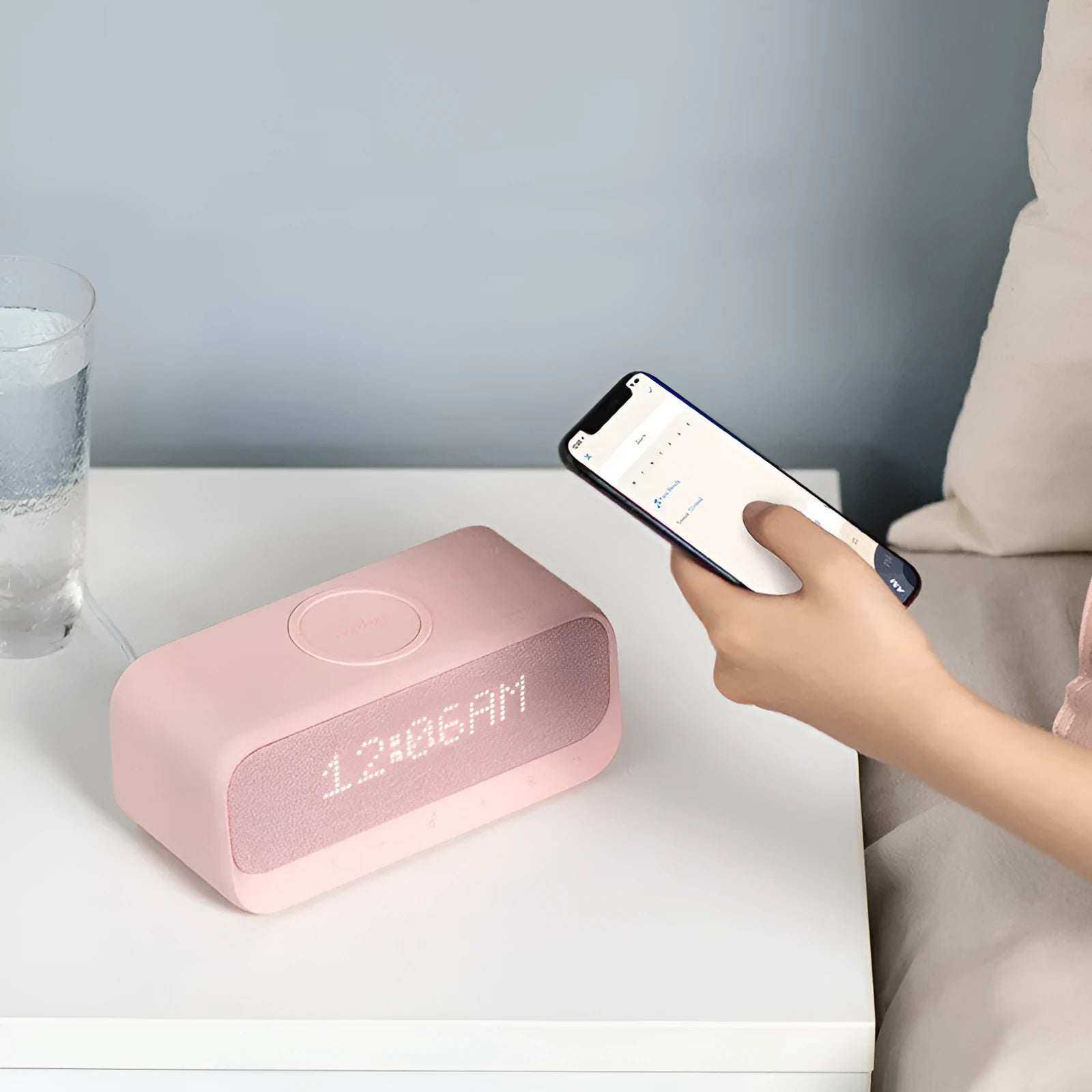Anker Soundcore white Bluetooth speaker with wireless charging pad and digital alarm clock display