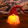Handmade Swedish gnome LED Christmas tree ornament with warm light, yarn plush body 8x20cm beige colour